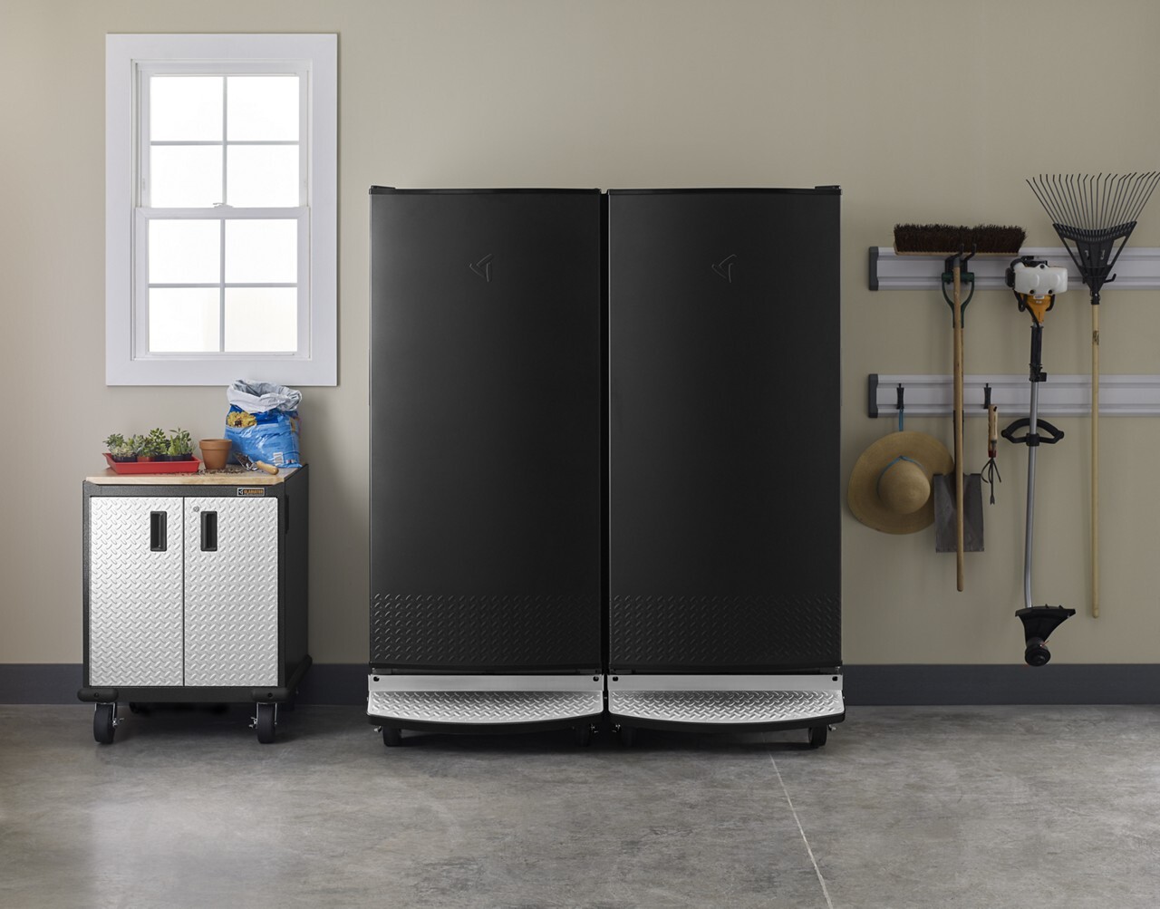 Organized garage featuring garage-ready refrigerator and freezer